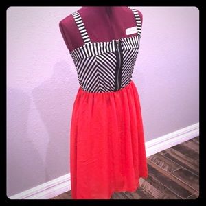 Asymmetrical hem dress. Orange and black/white